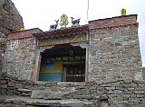 Tibet Kailash 08 Kora 12 Chuku Gompa Outside I crossed the bridge and huffed and puffed uphill through a maze of boulders for 20 minutes to Chuku (or Nyenri) Gompa (4820m), perched high above the valley floor on the hillside to the west. Chuku Gompa was founded by G�tsangpa (1189-1258), a Kagyu disciple, and was the first Kailash Gompa to be rebuilt after the destruction of Cultural Revolution. Inside there�s a highly unusual, original marble statue called Chuku Amitabha originally from India and reputed to talk, a silver inlaid conch shell that is said to have flown here from Bodh Gaya, peacock feathers and the tusks of a sacred elephant associated with Padmasambhava, and a large copper pot brought from India by Naropa.